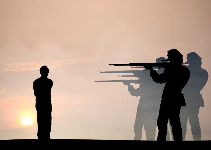 Silhouette of soldiers firing squadding a person