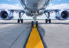 Airplane on runway with visible landing gear engines