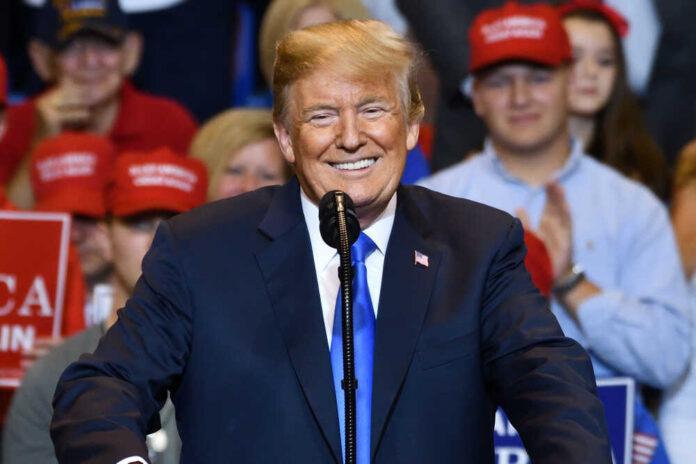 shutterstock_1155247306.jpg featured image Donald Trump speaking at a rally, supporters in background.