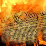 Burning U.S. Constitution amidst flames.