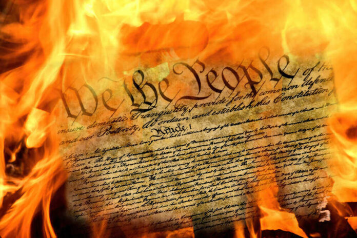shutterstock_1799756236.jpg featured image Burning U.S. Constitution amidst flames.