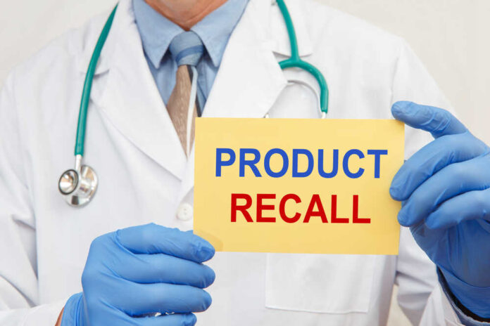 shutterstock_1849024102.jpg featured image Doctor holding a product recall sign in gloves