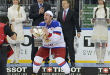 Alexander Ovechkin, hockey player celebrating with trophy on ice rink