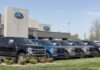 Ford dealership with trucks lined up outside