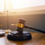 Gavel and scales of justice on desk.