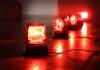 Red emergency lights on a dark floor