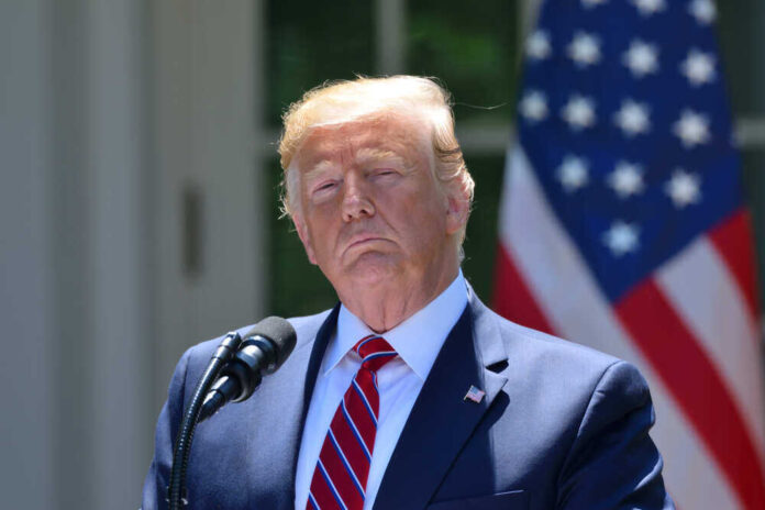 shutterstock_1432764869.jpg featured image Donald Trump speaking with US flag in the back.