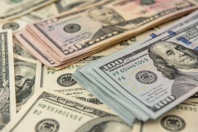shutterstock_1936085086.jpg featured image Stacks of US dollars featuring Benjamin Franklin and Ulysses S. Grant.