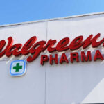 Signs for Walgreens and Pharmacy on building facade