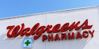 Signs for Walgreens and Pharmacy on building facade