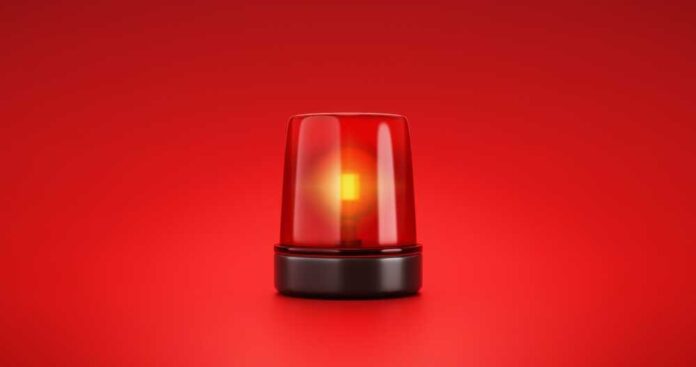 shutterstock_2053758056.jpg featured image Red emergency light flashing on a red background.