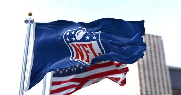 shutterstock_2116307702-1.jpg featured image NFL flag waving beside American flag.