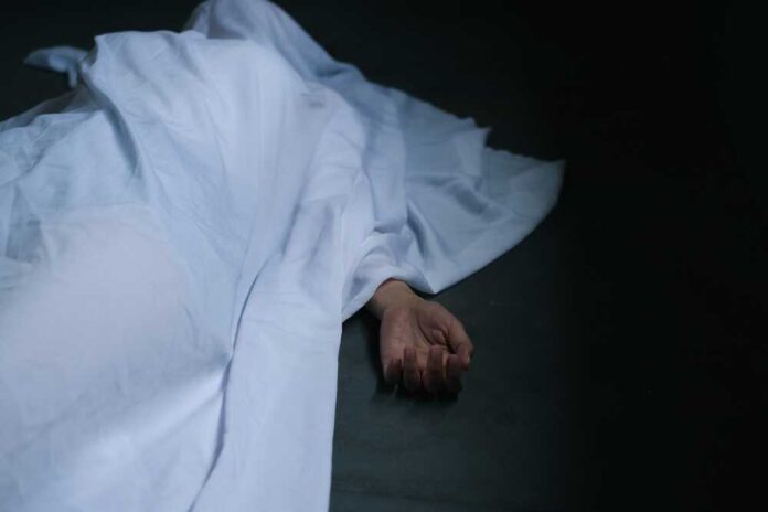 shutterstock_2194040069.jpg featured image Hand emerging from under white sheet on dark surface.
