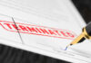 Termination document being signed with fountain pen