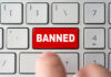 Red banned key on computer keyboard pressed