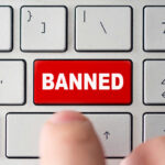 Red banned key on computer keyboard pressed