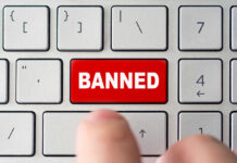 Red banned key on computer keyboard pressed