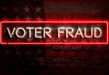 Neon sign reading Voter Fraud on American flag background.