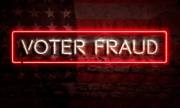 shutterstock_1794216790.jpg featured image Neon sign reading Voter Fraud on American flag background.