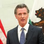 Gavin Newsom speaking at podium.
