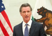 Gavin Newsom speaking at podium.