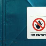 No entry sign on teal metal door background