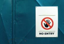 No entry sign on teal metal door background