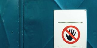 No entry sign on teal metal door background
