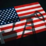 American flag with oil pump shadow overlay.