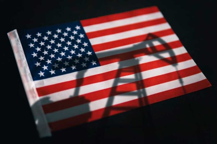 American flag with oil pump shadow overlay.