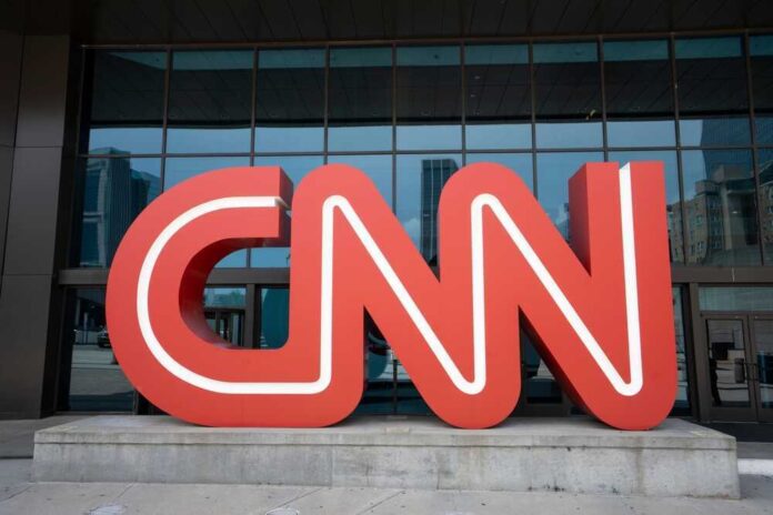 shutterstock_2408002237.jpg featured image Red CNN logo in front of glass building.