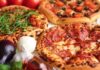 Three pizzas with various toppings and fresh ingredients.