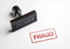 Fraud stamp and red stamped imprint on paper