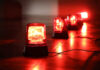 Red emergency lights on dark floor illuminating the area