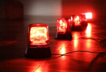 Red emergency lights on dark floor illuminating the area