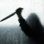 Silhouette of a man holding a knife