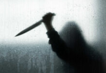Silhouette of a man holding a knife