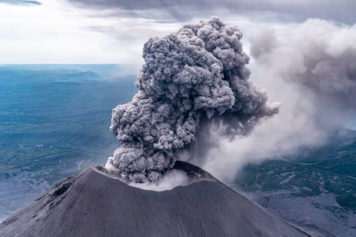 shutterstock_1990974674.jpg featured image Volcano erupting with large ash plume in sky