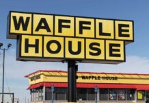 Waffle House sign in front of restaurant building.
