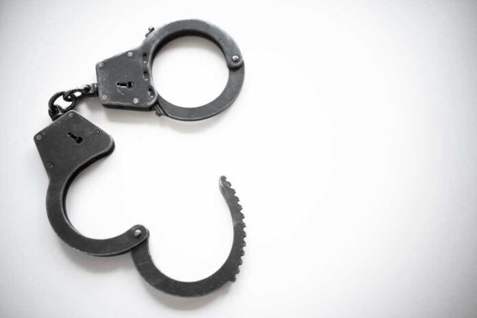 shutterstock_2116470560.jpg Open metal handcuffs on white background