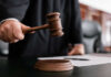 Judge holding gavel in courtroom