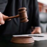 Judge holding gavel in courtroom