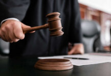 Judge holding gavel in courtroom