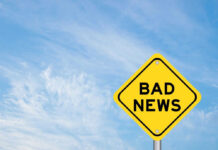 Yellow sign reads bad news in sky