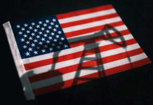 American flag with oil pump shadow overlay.
