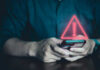 Person Holding Phone with Warning Symbol