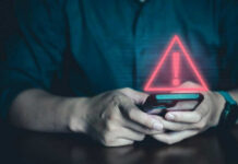 Person Holding Phone with Warning Symbol