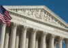 U.S. Supreme Court building with American flag.