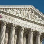 U.S. Supreme Court building with American flag.