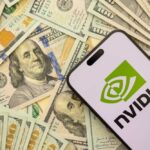 Hundred dollar bills and smartphone showing Nvidia logo